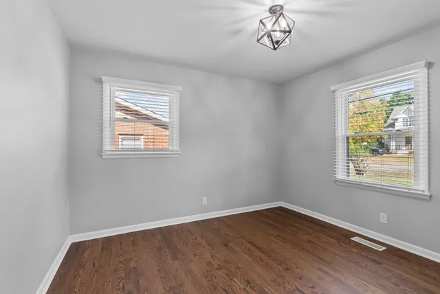 a view of a room with wooden floor and window