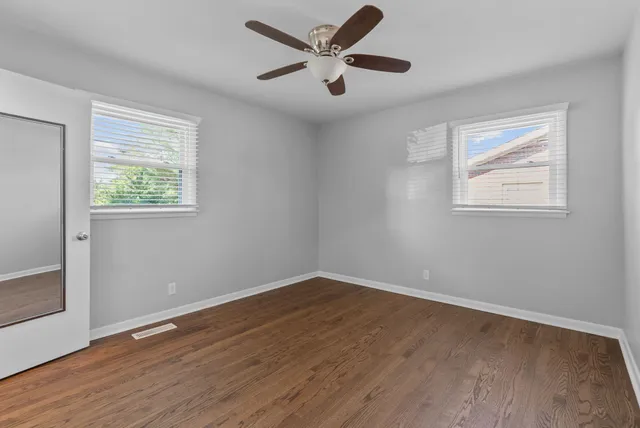 a view of a room with wooden floor and a bathroom
