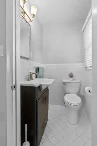 a bathroom with a toilet a sink and a window