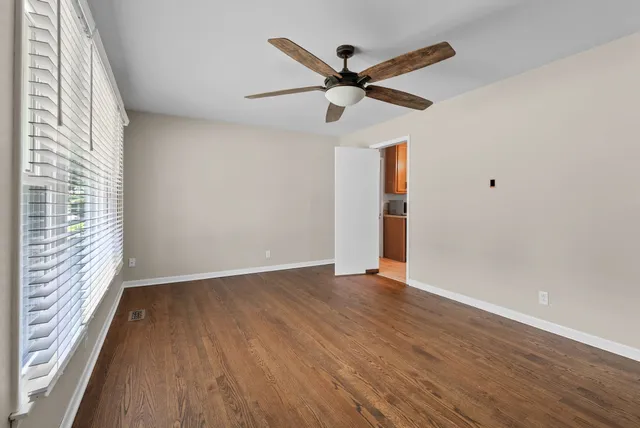 wooden floor in an empty room with a window
