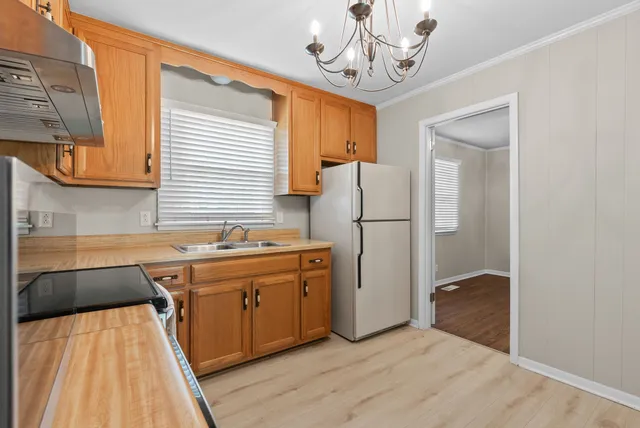 a kitchen with stainless steel appliances granite countertop a stove and a refrigerator