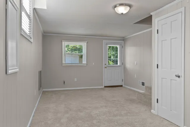 an empty room with windows and closet