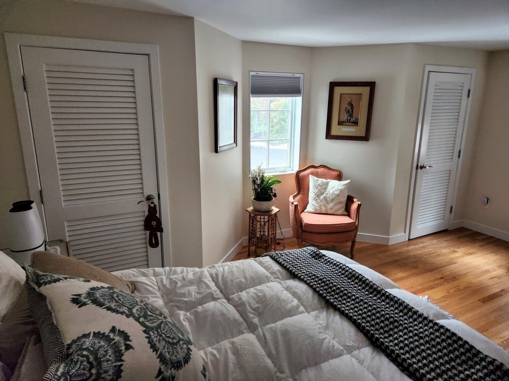 11 Low Street, Unit 1 Newbury, MA 01951 - Photo 11 of 14 a bedroom with a bed and wooden floor