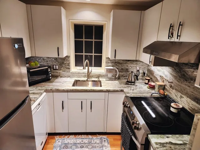 a kitchen with a stove and a refrigerator