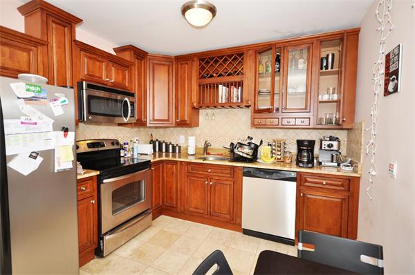 a kitchen with stainless steel appliances granite countertop a stove a sink dishwasher and a microwave oven with cabinets