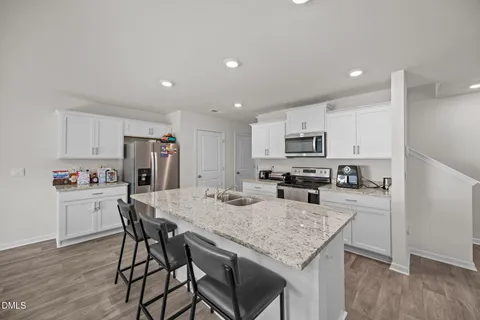 a dining room with furniture a window and kitchen view