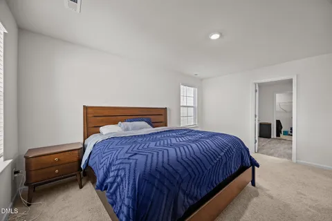 a spacious bedroom with a bed and a window
