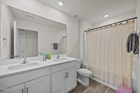 a room with lots of furniture and wooden floor