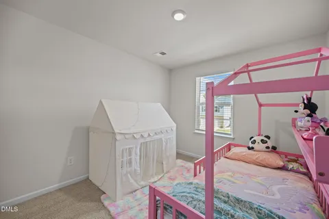 a bedroom with a bed and dresser