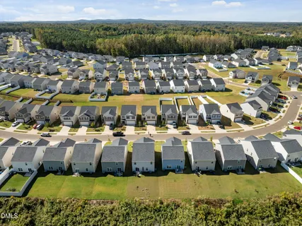 an aerial view of a swimming pool with outdoor seating