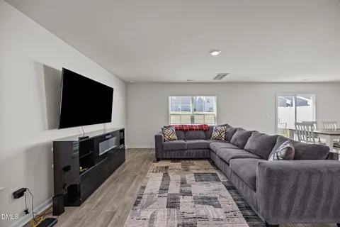 a living room with furniture and kitchen view