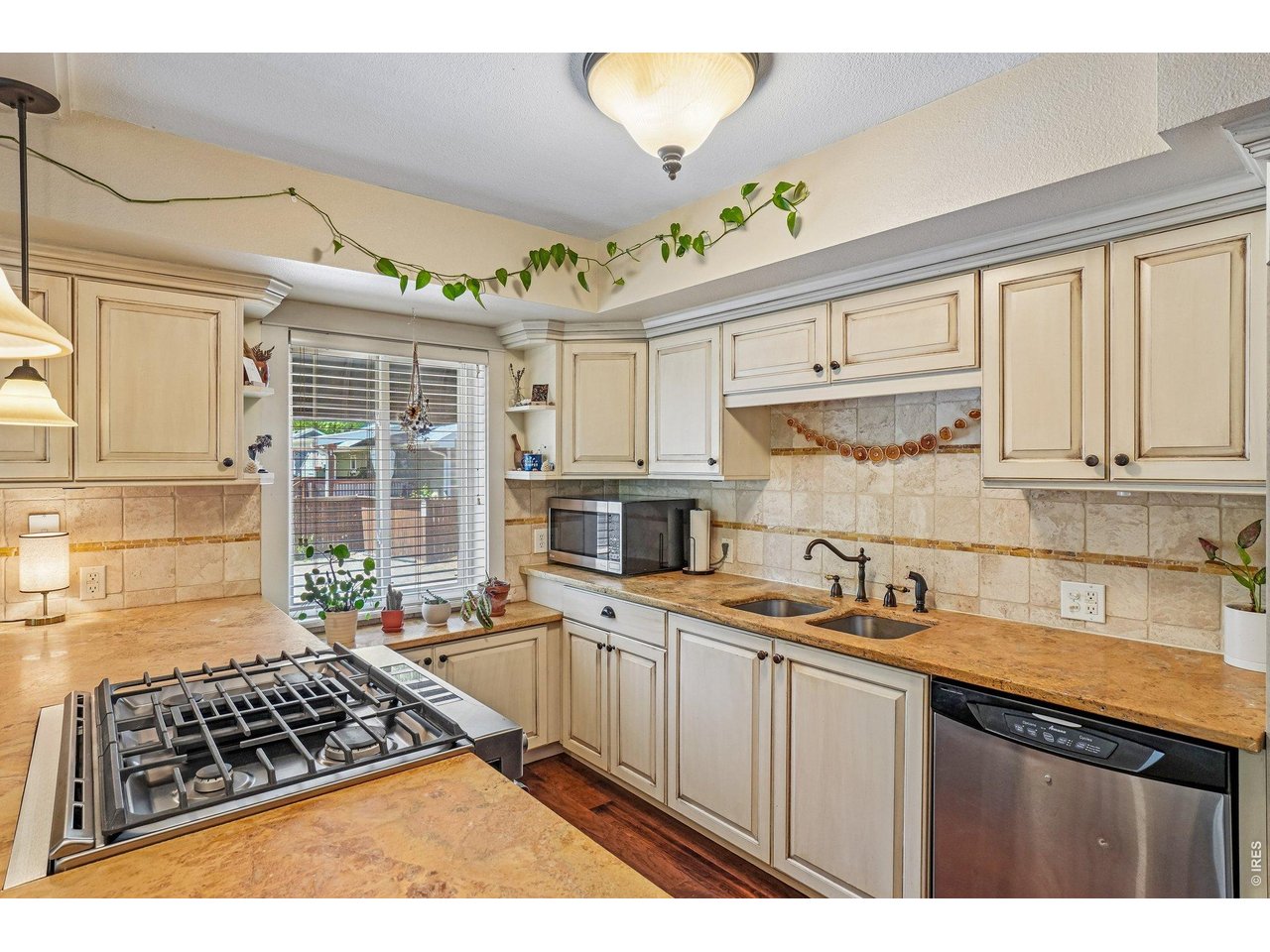 233 North Meldrum Street, Unit 4 Fort Collins, CO 80521 - Photo 7 of 16 a kitchen with stainless steel appliances a stove a sink and a microwave