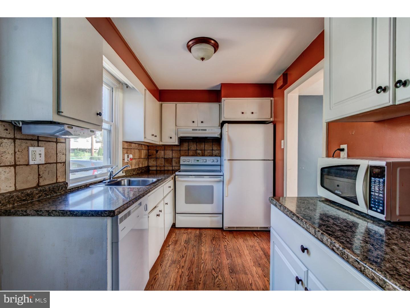 204 Pine Ridge Road Havertown, PA 19083 - Photo 4 of 24 a kitchen with stainless steel appliances granite countertop a refrigerator a stove a sink and a microwave