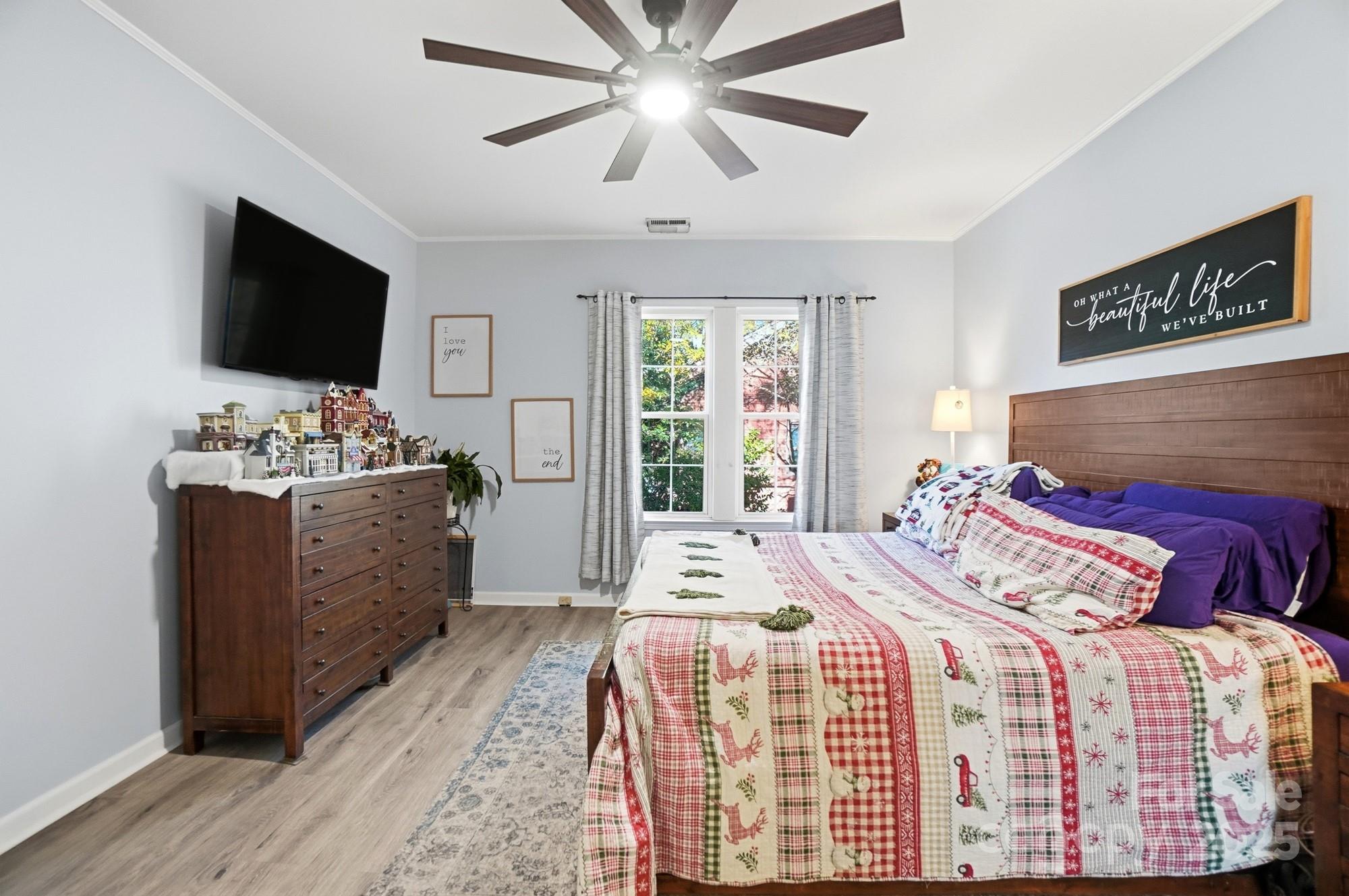 1607 Florida Street Gastonia, NC 28052 - Photo 14 of 24 a bedroom with a bed and a flat screen tv