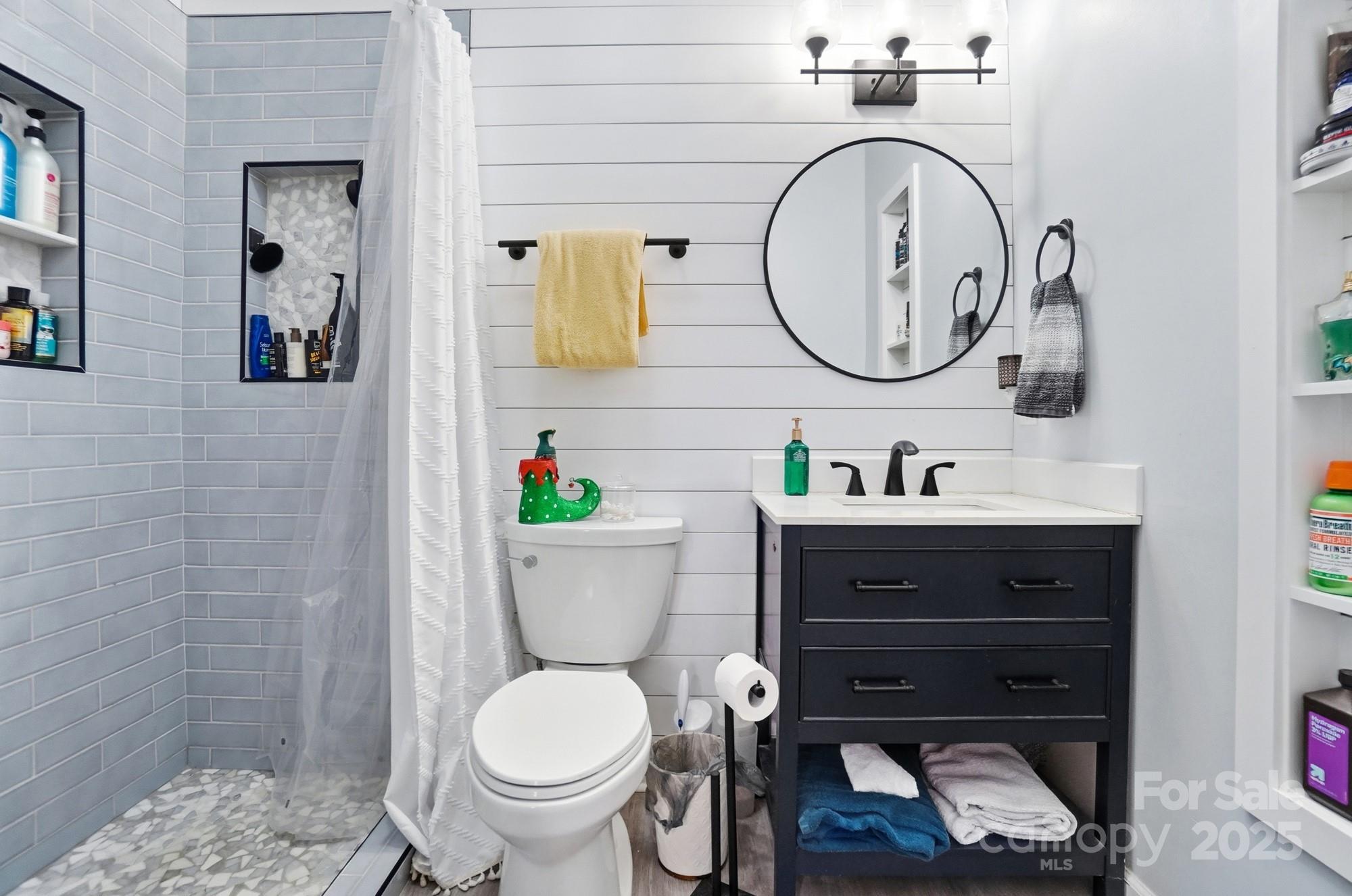 1607 Florida Street Gastonia, NC 28052 - Photo 15 of 24 a bathroom with a toilet a sink and a mirror