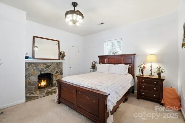a bedroom with bed and a fireplace