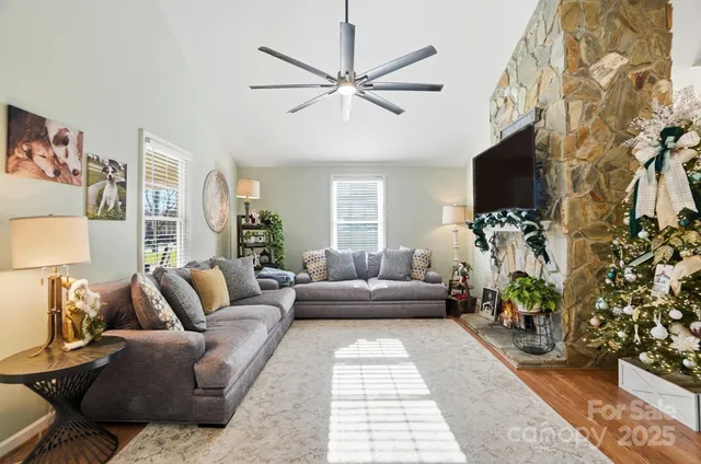 a living room with furniture a flat screen tv and a potted plant