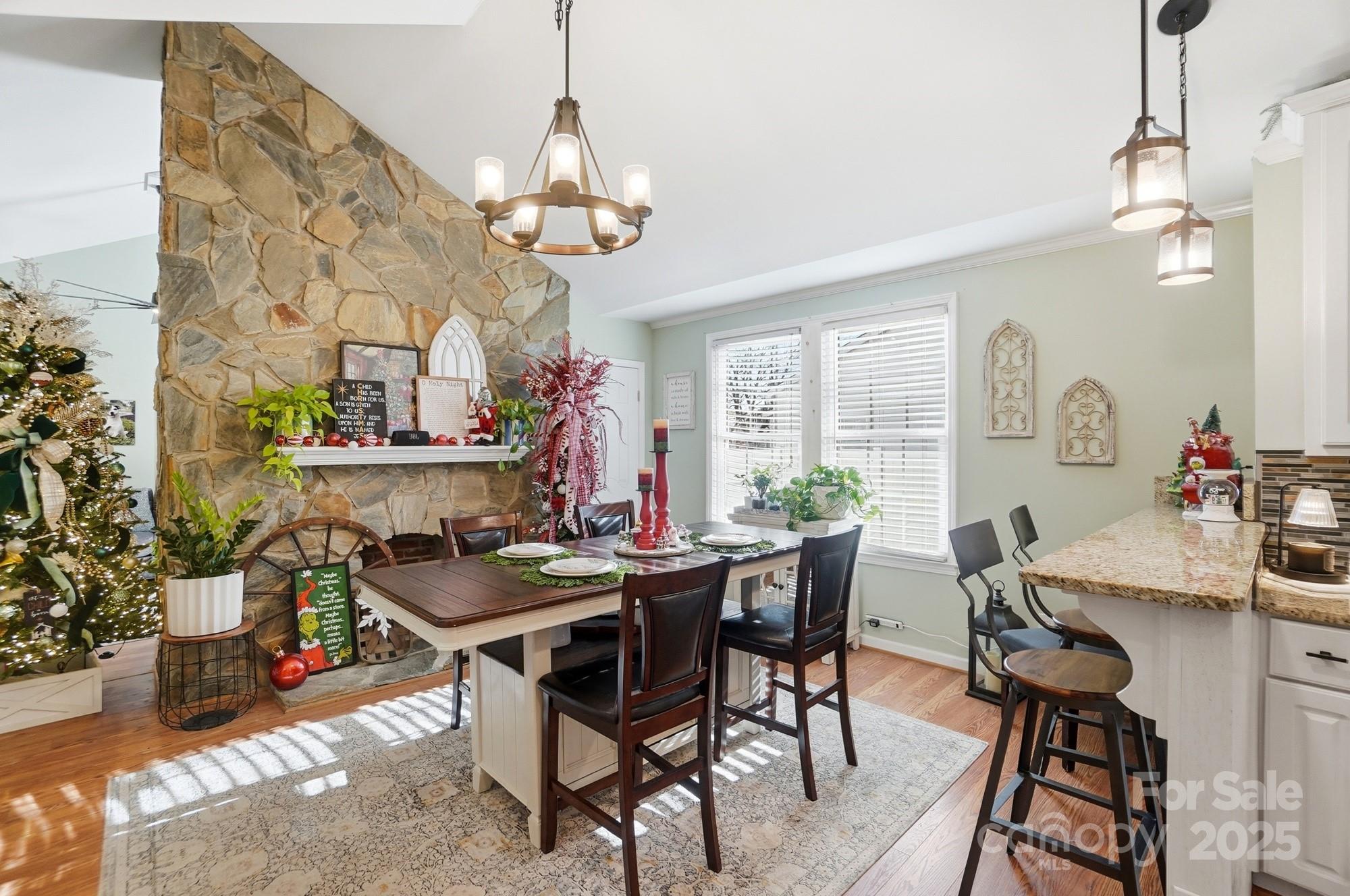 1607 Florida Street Gastonia, NC 28052 - Photo 9 of 24 a view of a dining room with furniture a chandelier and wooden floor
