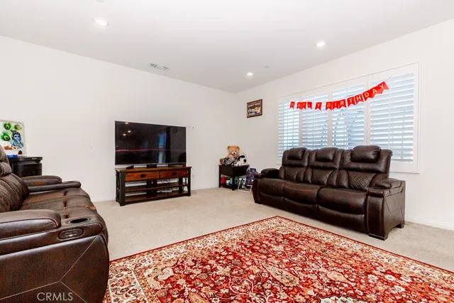 a living room with furniture and a rug