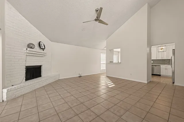 a view of an empty room with a fireplace