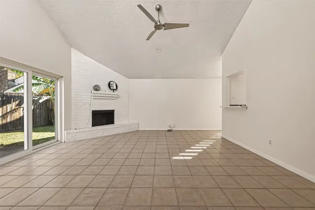 a view of a livingroom with an empty space and a fireplace