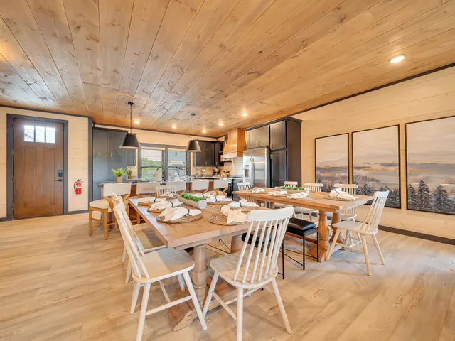 a dining room with furniture window and wooden floor