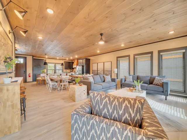 a living room with lots of furniture and a large window