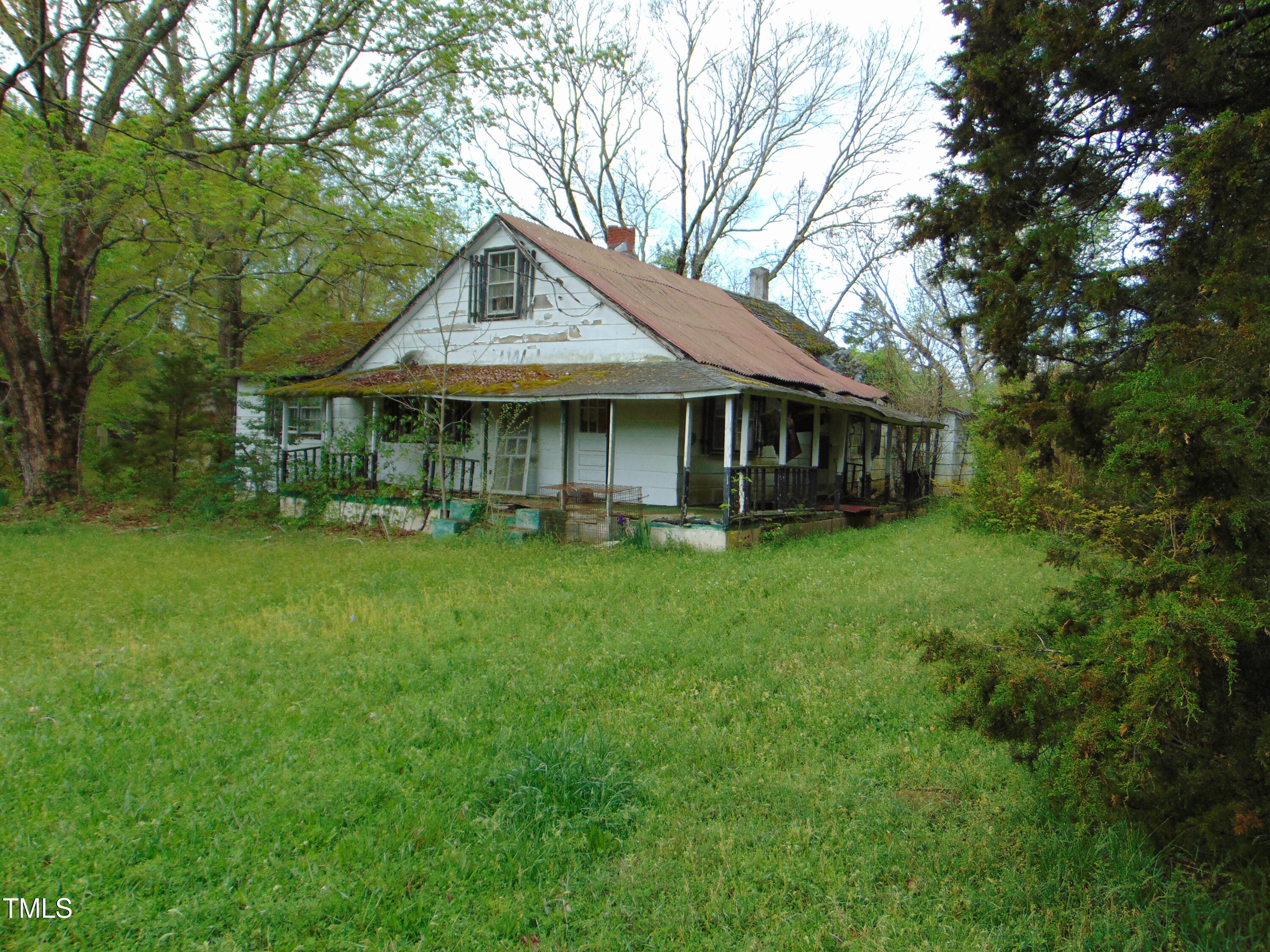 1594 Us Highway Kittrell, NC 27544 - Photo 4 of 24 a backyard of a house with yard table and chairs