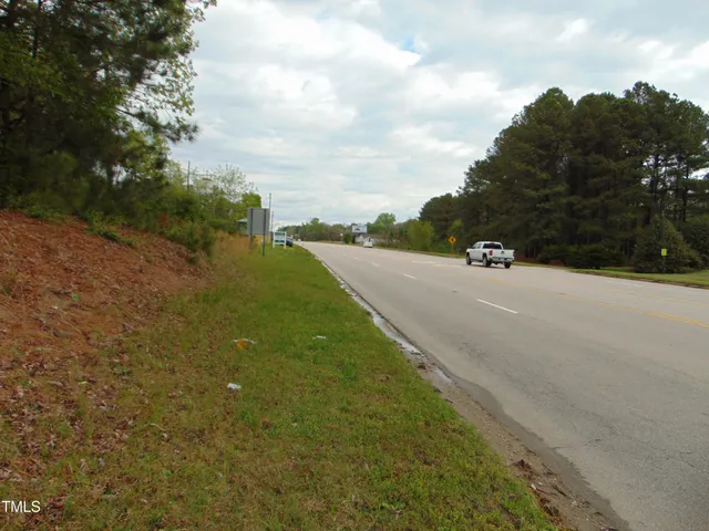 a view of a street with an trees in the background