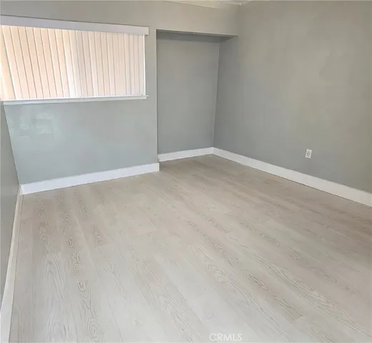 wooden floor in an empty room with a mirror