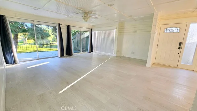 a view of an empty room with a fireplace and a window
