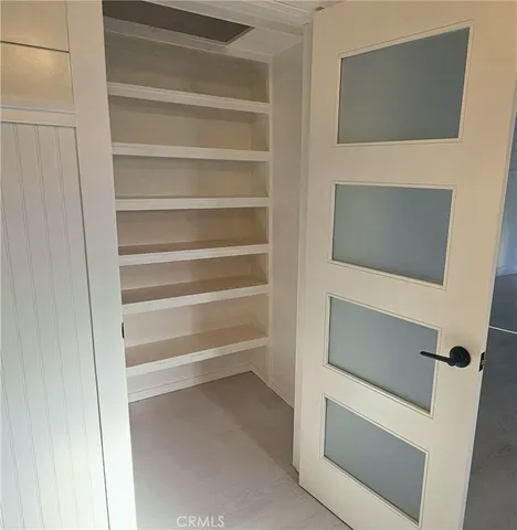 a bathroom with cabinet a mirror and vanity