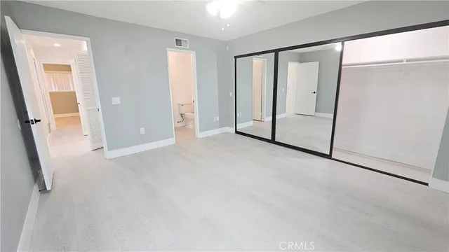 a white toilet sitting next to a white sink