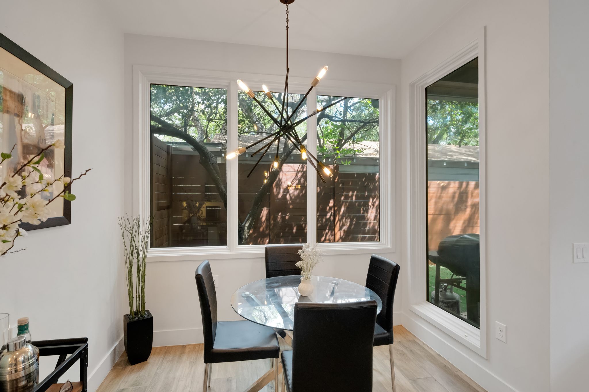 809 Bouldin Avenue Austin, TX 78704 - Photo 32 of 39 Dining room featuring light wood-style flooring and a chandelier