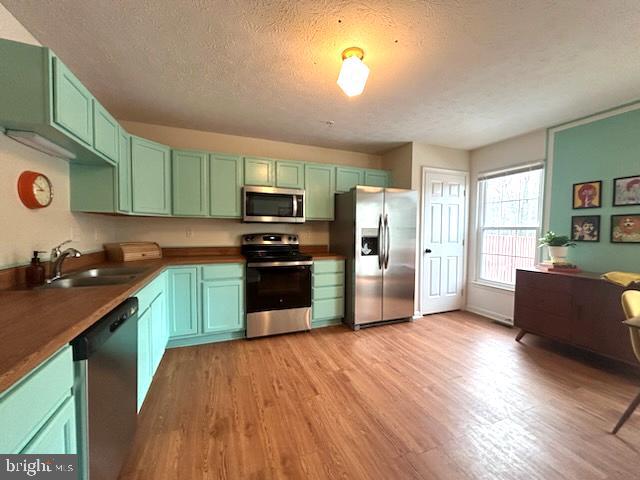 1703 Bluffs Island Court Odenton, MD 21113 - Photo 11 of 38 a kitchen with stainless steel appliances granite countertop a refrigerator a stove top oven a sink dishwasher and wooden floor