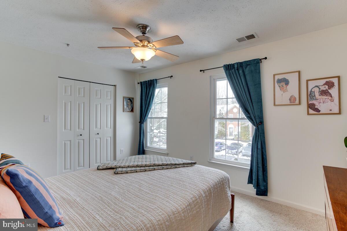 1703 Bluffs Island Court Odenton, MD 21113 - Photo 17 of 38 a bedroom with a bed and a window