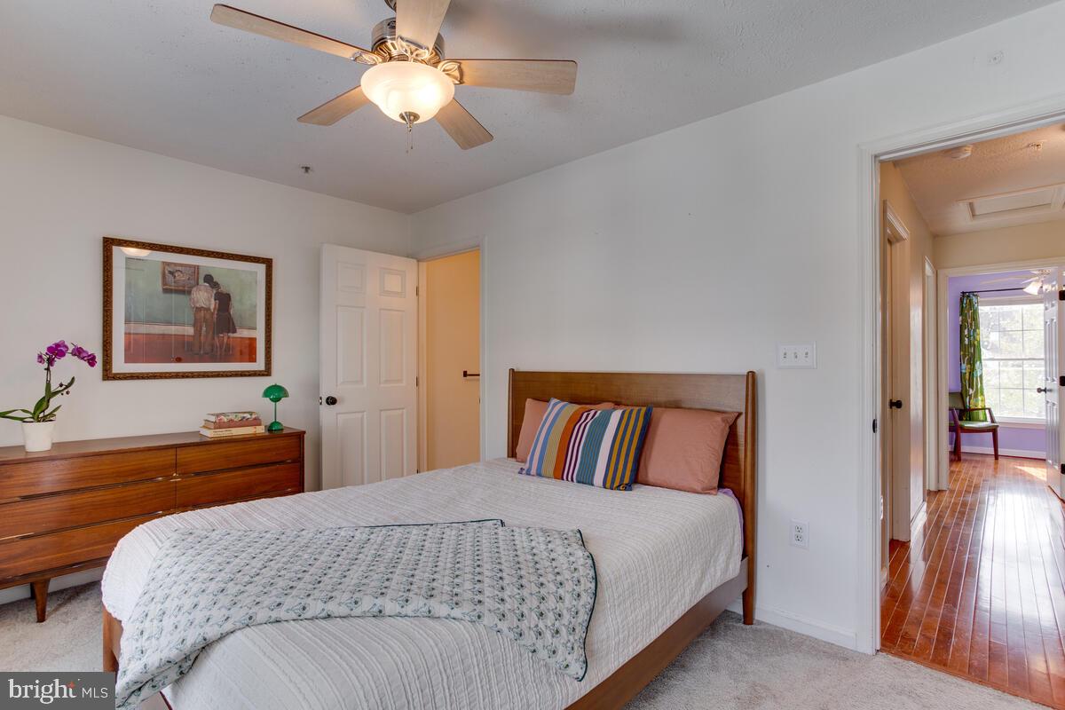 1703 Bluffs Island Court Odenton, MD 21113 - Photo 18 of 38 a bedroom with a bed and a chandelier