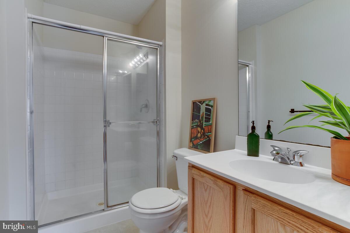 1703 Bluffs Island Court Odenton, MD 21113 - Photo 19 of 38 a bathroom with a sink toilet and shower
