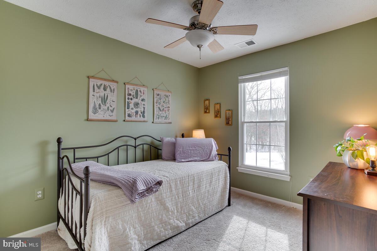 1703 Bluffs Island Court Odenton, MD 21113 - Photo 20 of 38 a bedroom with a bed window and a table