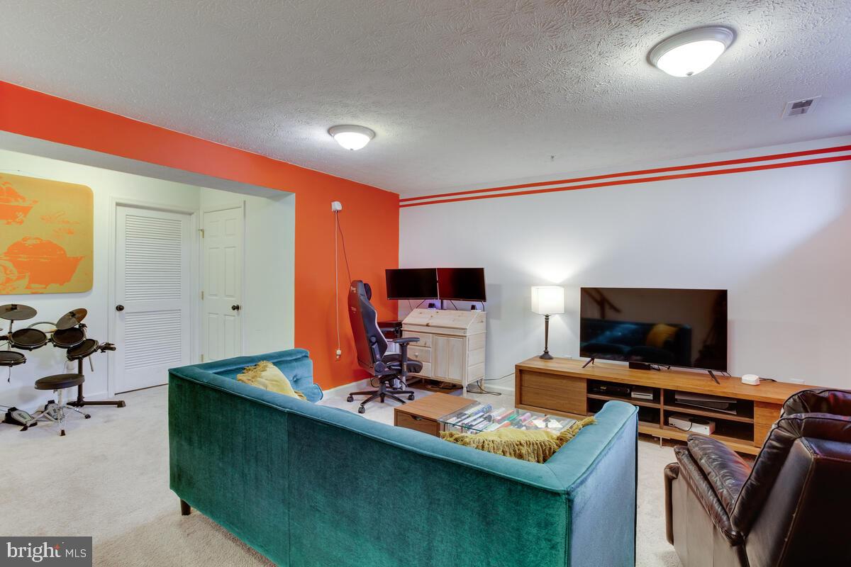 1703 Bluffs Island Court Odenton, MD 21113 - Photo 27 of 38 a living room with furniture and a flat screen tv