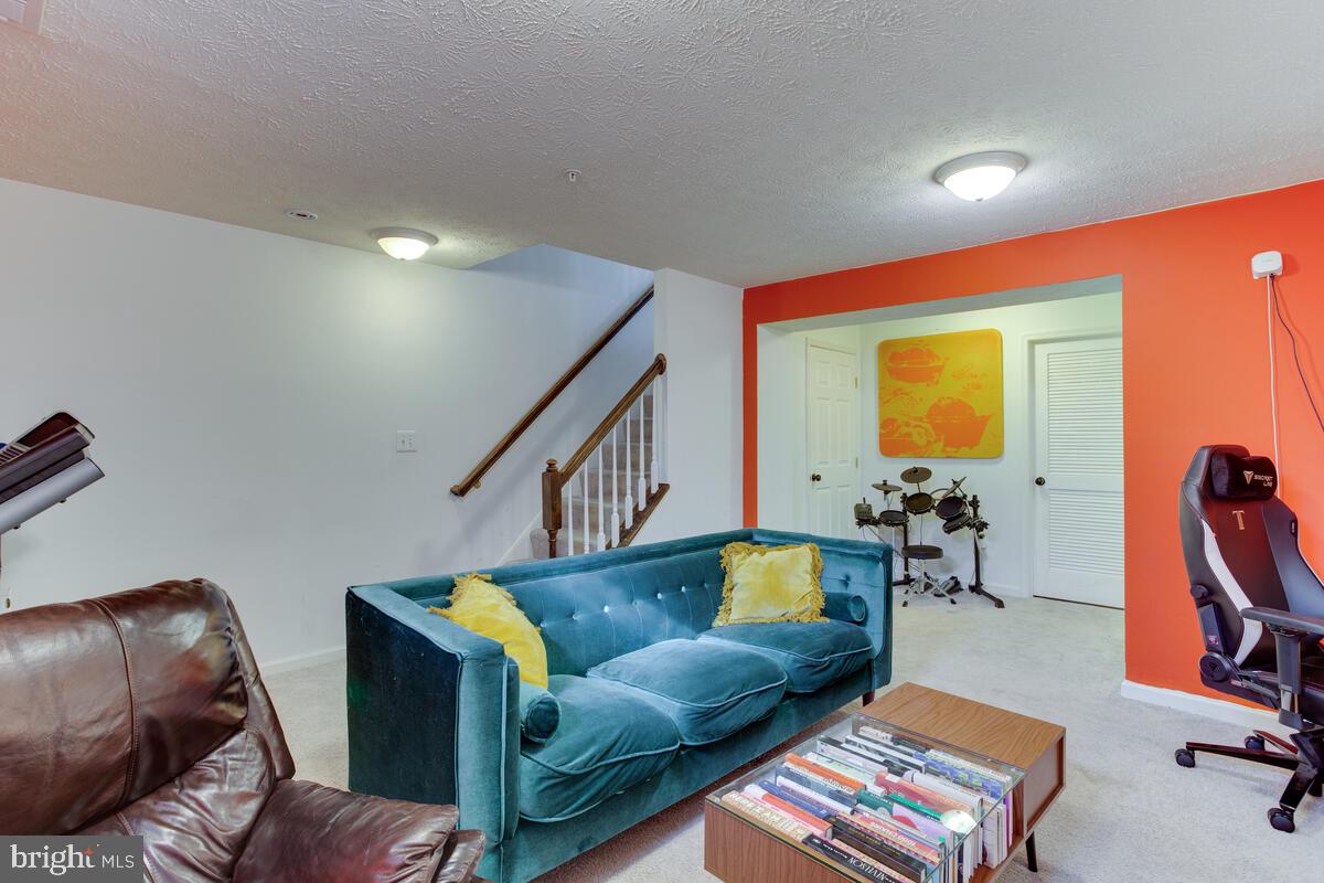 1703 Bluffs Island Court Odenton, MD 21113 - Photo 29 of 38 a living room with furniture and a flat screen tv