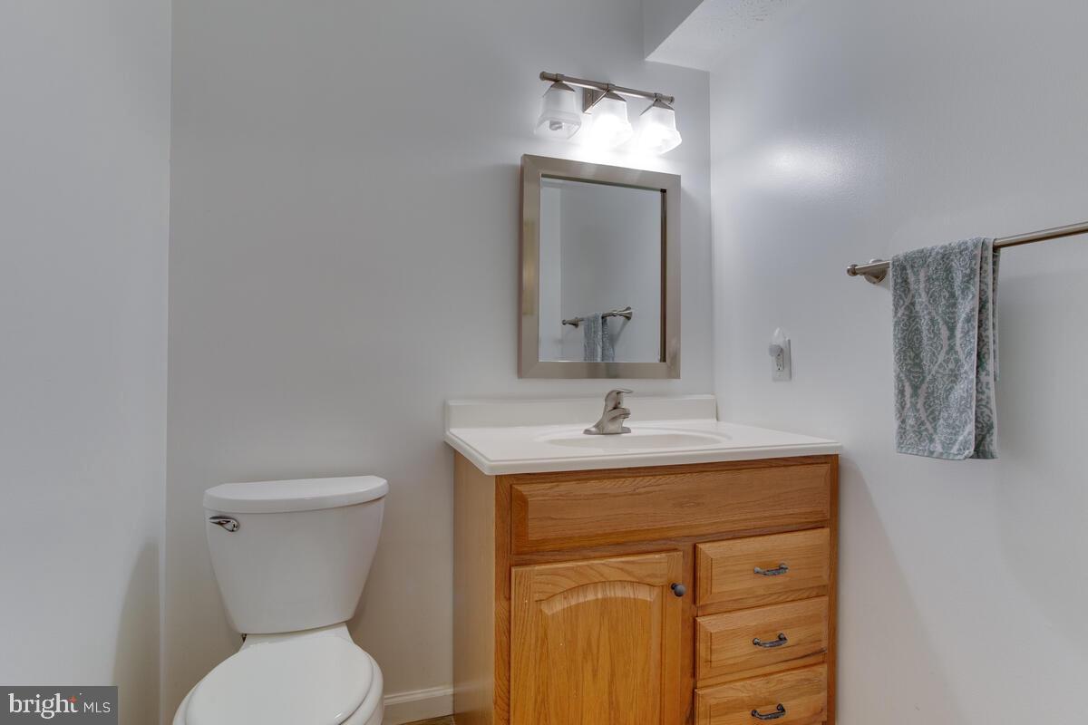 1703 Bluffs Island Court Odenton, MD 21113 - Photo 30 of 38 a bathroom with a toilet a sink and mirror