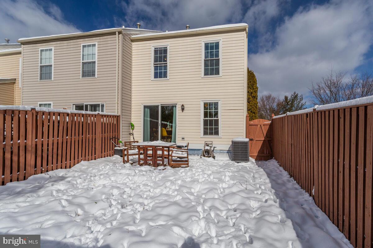 1703 Bluffs Island Court Odenton, MD 21113 - Photo 33 of 38 a backyard of a house with wooden fence and deck
