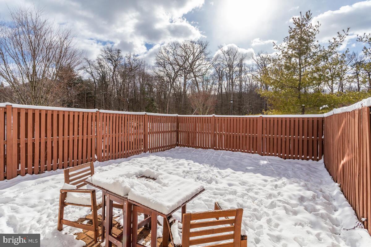 1703 Bluffs Island Court Odenton, MD 21113 - Photo 34 of 38 a view of a backyard with a fence and trees
