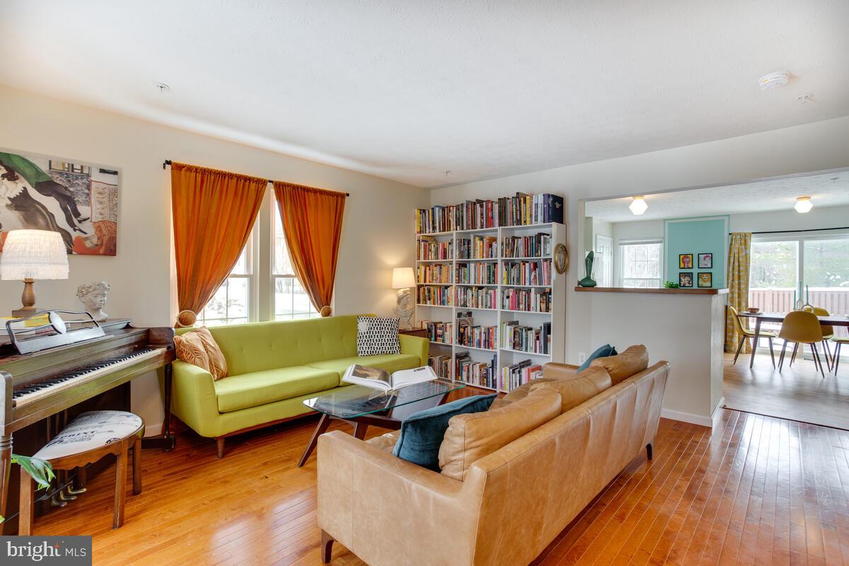 1703 Bluffs Island Court Odenton, MD 21113 - Photo 4 of 38 a living room with furniture and a book shelf