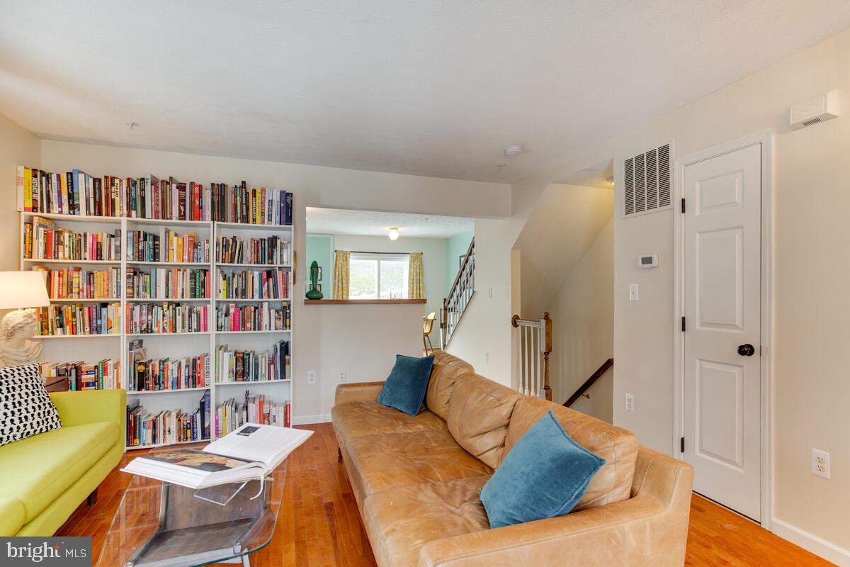 1703 Bluffs Island Court Odenton, MD 21113 - Photo 7 of 38 a living room with furniture and a book shelf