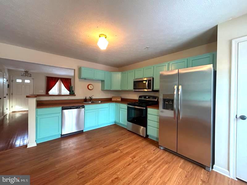 1703 Bluffs Island Court Odenton, MD 21113 - Photo 8 of 38 a kitchen with stainless steel appliances granite countertop a refrigerator and a sink