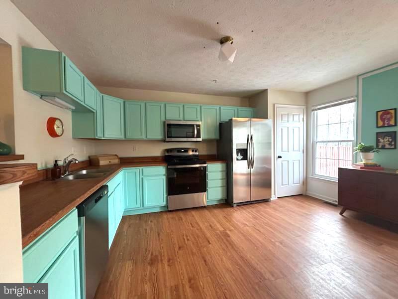 1703 Bluffs Island Court Odenton, MD 21113 - Photo 9 of 38 a kitchen with stainless steel appliances granite countertop a refrigerator and a stove top oven