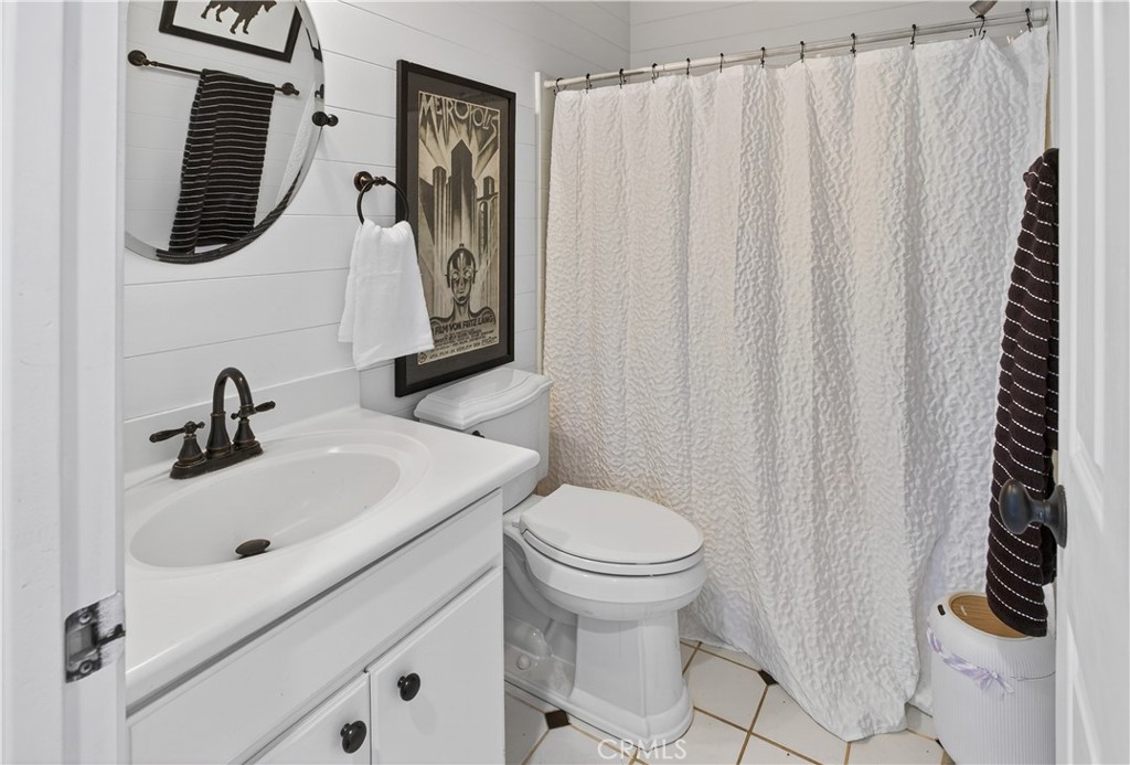 31928 Cercle Chambertin Temecula, CA 92591 - Photo 32 of 74 a bathroom with a sink a toilet and a mirror