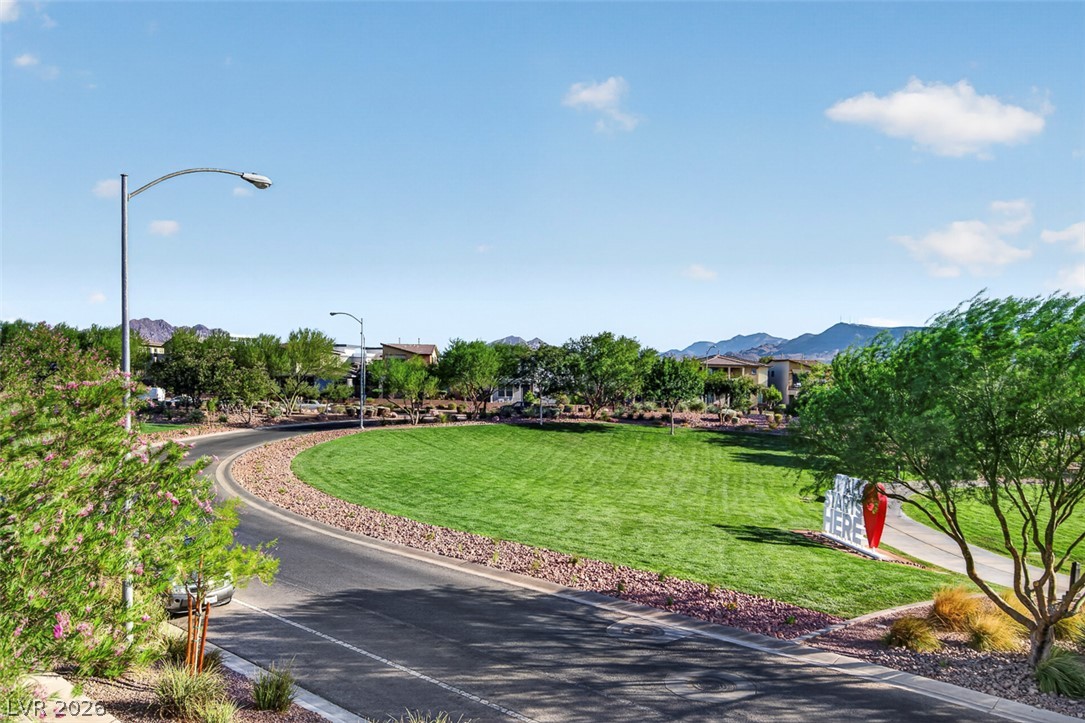 1100 East Sunset Road Henderson, NV 89011 - Photo 44 of 58 Rolling green landscape and paved streets wind through this inviting community, framed by distant mountains.